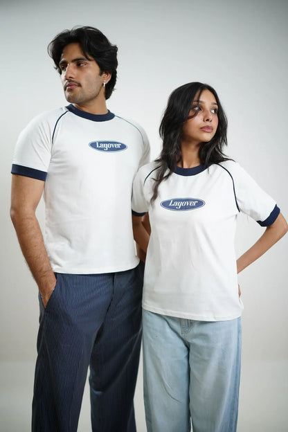 Two people wearing white t-shirts with 'Layover' logo on a plain white background