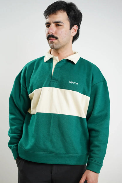 Man wearing a green and beige sweater with 'Layover' branding on a white background