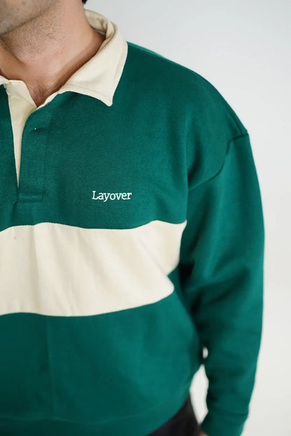 Green and beige rugby sweater with 'Layover' text on a white background